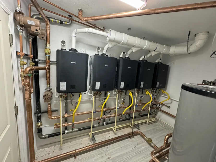Bank of Rinnai tankless water heaters with clean copper and gas piping installed by Eco Water Solutions in a DFW home